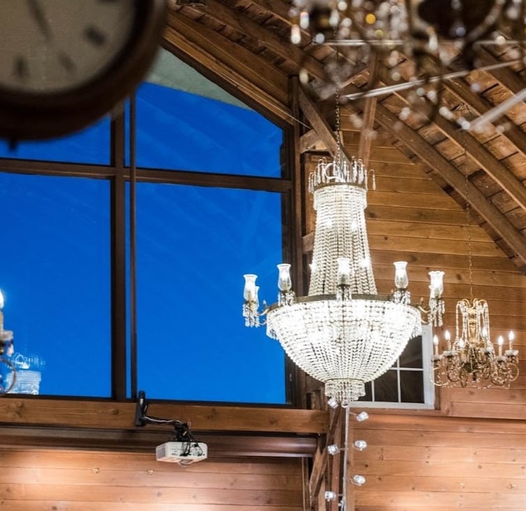 High ceilings at a barn venue with chandeliers